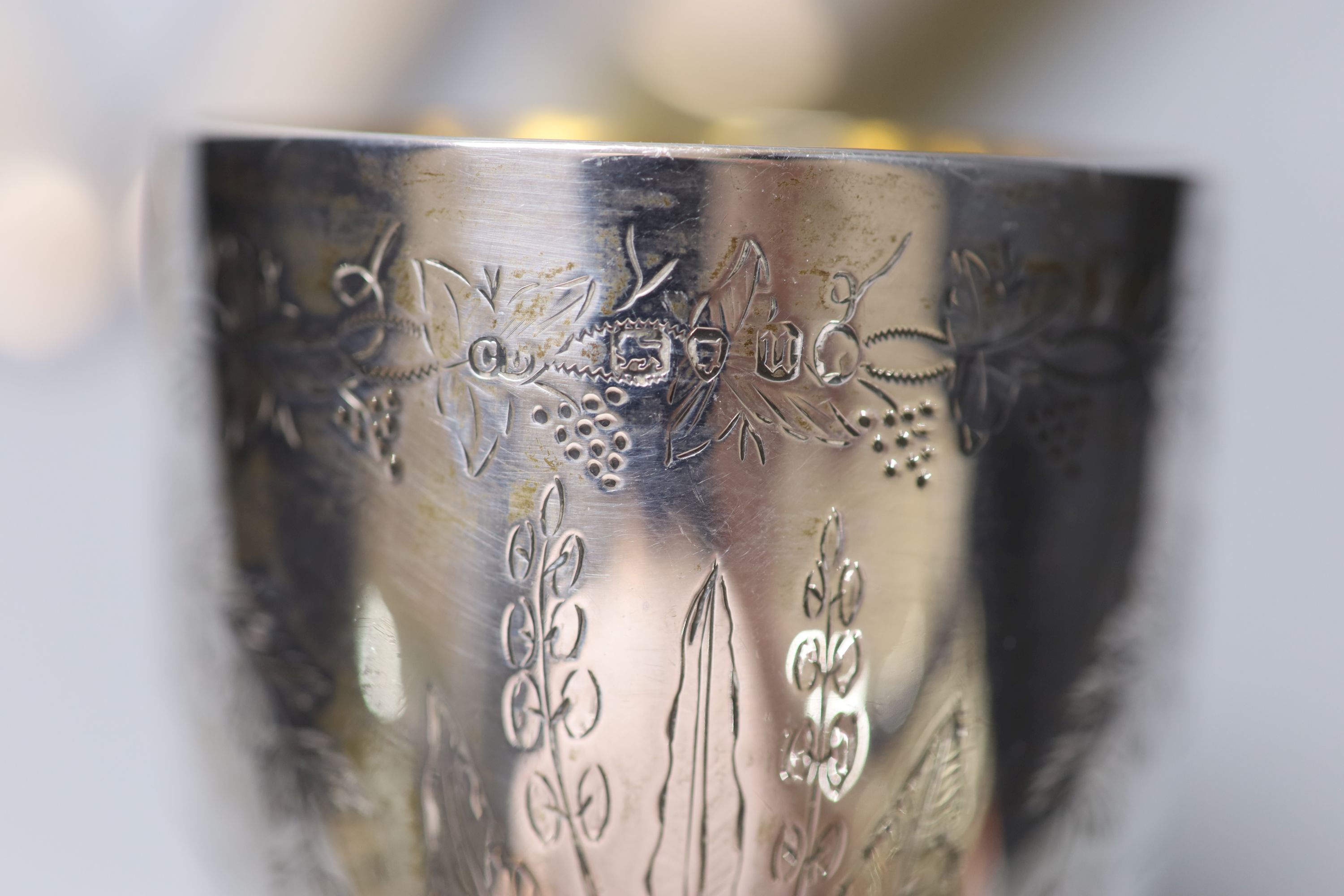 A Victorian engraved silver goblet, London, 1875, 6.3cm, a pair of silver sugar tongs and four silver mounted brushes.